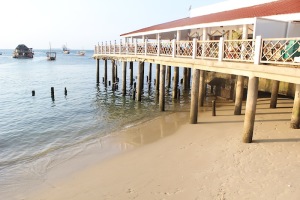 The pier with a restaurant and beautiful sand underneath